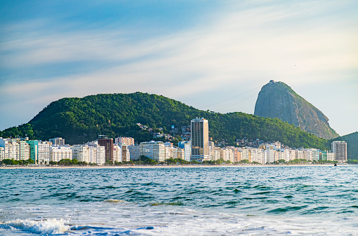 Coastline of Copacabana beach, the sea, the buildings and the sugarloaf in the  background