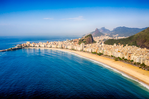 Coastline of Copacabana beach, the sea, the buildings and the hills at background