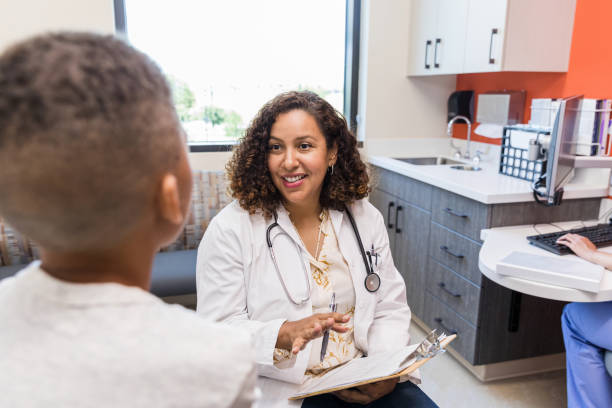 istock Female pediatrician talks to the young patient 1419970704