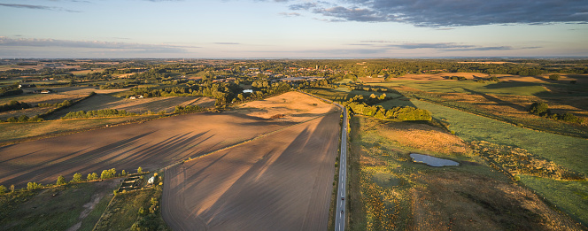 Mixed nature and agricultural fields. Panoramic wide angle image at dawn
