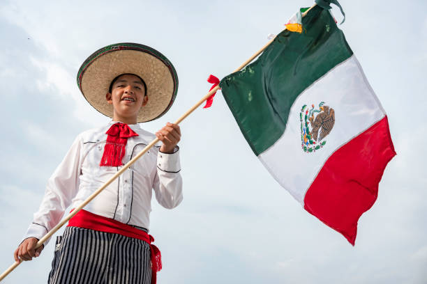 istock Young boy holding flag of Mexico 1419972433