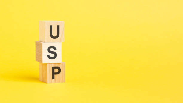 istock USP - Unique Selling Proposition - text on wooden block with yellow background. 1419973662
