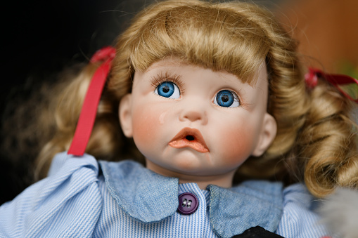 Portrait of a vintage doll girl at the flea market
