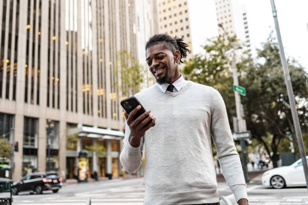 istock Confident  African-American young man using mobile phone on the street 1419980766
