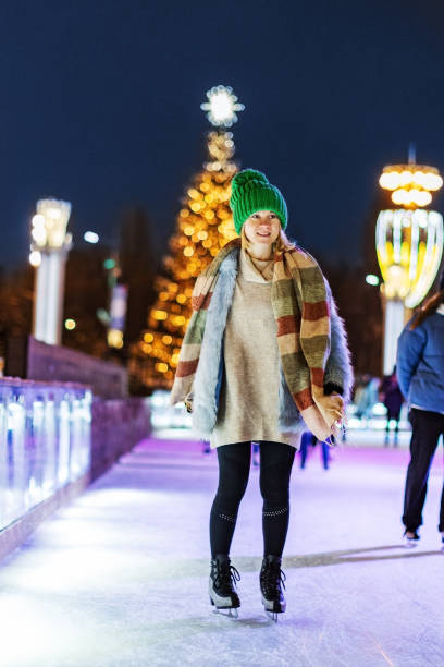 istock Young woman ice skating at Christmas ring 1419980830