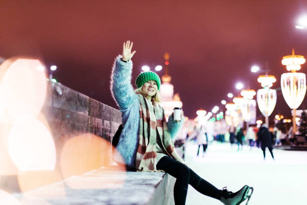 Young woman ice skating at Christmas