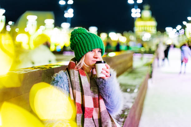 Young woman ice skating at Christmas