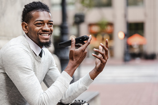 African-American man on the street, he is using smart phone