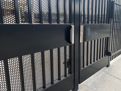 a steel iron prison security gate metal mesh protection secure gates door industrial entrance doors