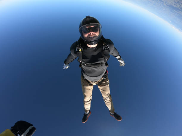 pov as skydivers fall upside down, in aerial flight - mountain drop europe switzerland imagens e fotografias de stock