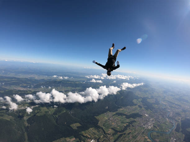 istock Skydiver falls upside down, over Swiss countryside 1419984815