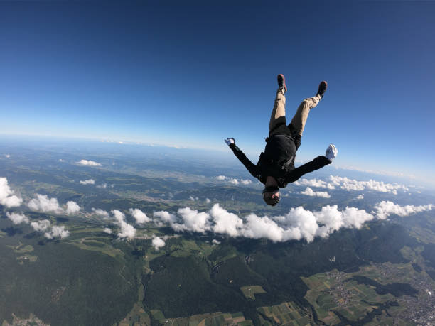 istock Skydiver falls upside down, over Swiss countryside 1419984817