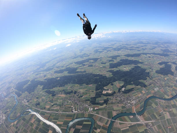 istock Skydiver falls upside down, over Swiss countryside 1419984822