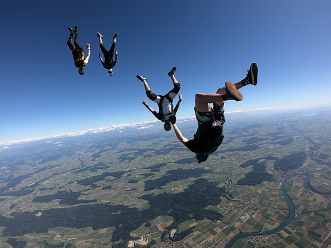 They fly over Swiss countryside, on a summer morning