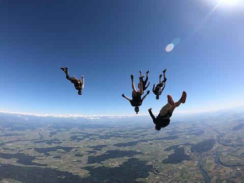 They fly over Swiss countryside, on a summer morning