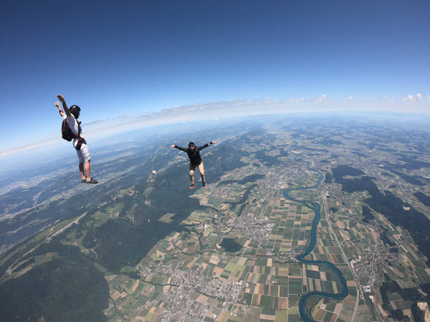 istock Skydivers fall over Swiss countryside, in aerial flight 1419985022