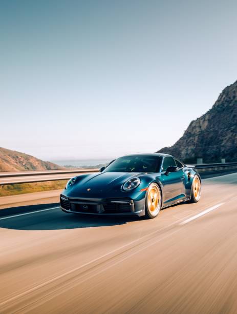 LA, CA, USA8/12/2022Porsche 911 Turbo S driving on the street with mountains in the background