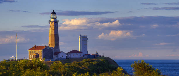 Montauk Point Lighthouse Ocean View Montauk Point Lighthouse in Montauk Point State Park, Long Island, New York, in setting sunlight with Atlantic Ocean in the background. montauk point stock pictures, royalty-free photos & images