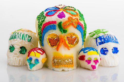 photo of traditional day of the dead sugar skulls on a white background