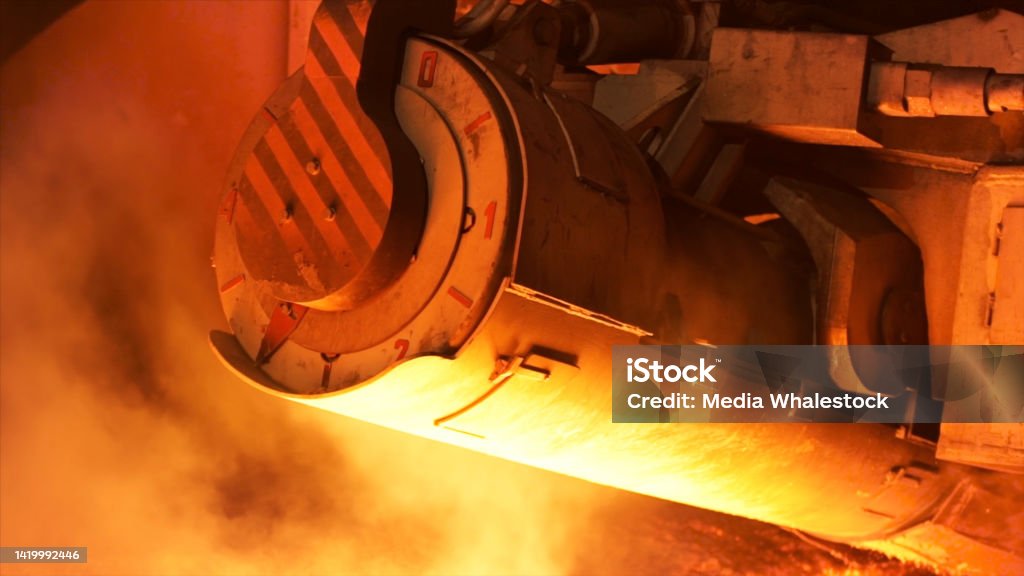 Close up for mechanism detail, steel production at a metallurgical plant. Stock footage. Heavy industry and steelworks. Close up for mechanism detail, steel production at a metallurgical plant. Heavy industry and steelworks. Dead Stock Photo
