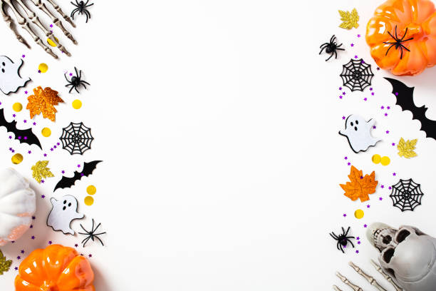 istock Happy Halloween holiday greeting card template. Flat lay composition with Halloween decorations, pumpkins, skeleton arms, skull, bats, spiders, ghosts on white background. Top view, copy space. 1419994004