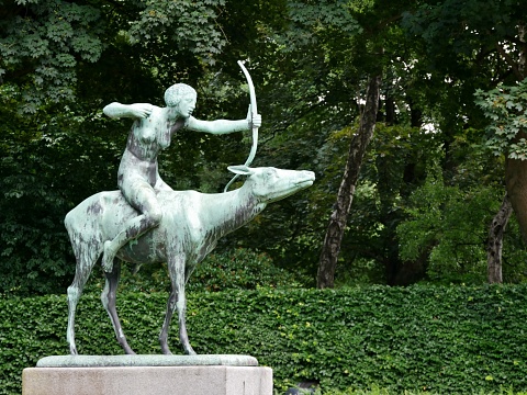 Lady on horse with bow and arrow in the city park