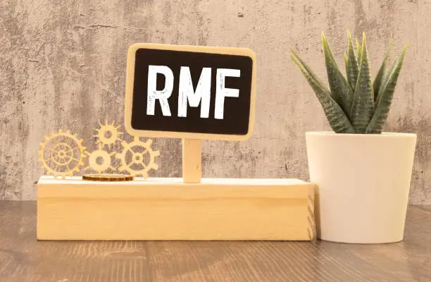 Businessman hand with pen pointing to RMF sign on the paper