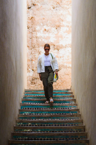 woman walking down stairs stock photo