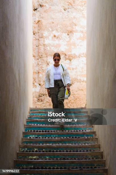 Woman Walking Down Stairs Stock Photo - Download Image Now - Marrakesh, Adult, Adults Only