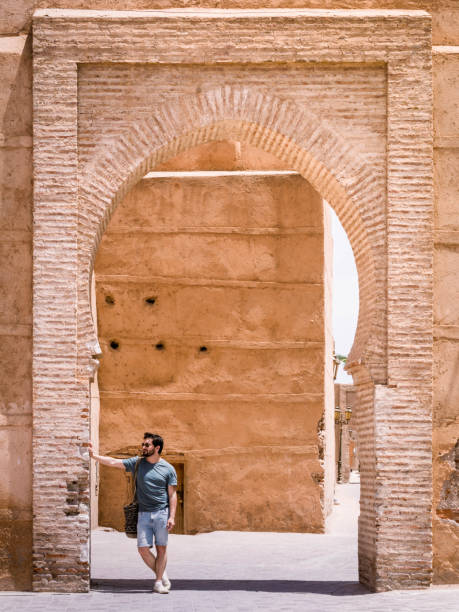 Man leaning on an archway in morocco stock photo