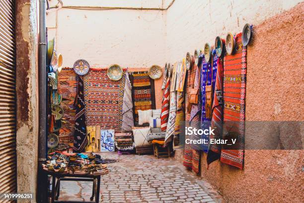 Moroccan Street With Carpet Weaving Stock Photo - Download Image Now - Rug, Ancient, Architecture