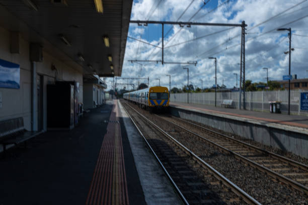 Commuter train approaching a train station in Melbourne Victoria Australia