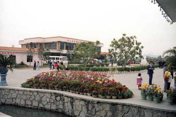 British Hong Kong, China - 1983: A vintage 1980's Fujifilm negative film scan of buildings and a small pond located in Kowloon Park, in Hong Kong, China.