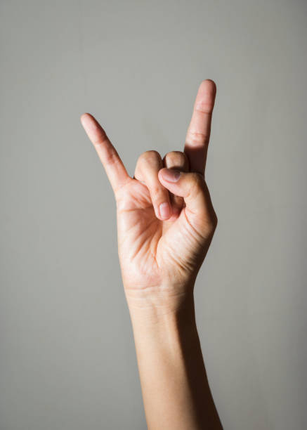 istock Female hand showing rock and roll symbol. 1420003705