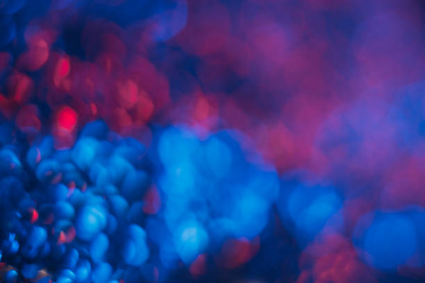 Bokeh light overlay. Blur neon flare. Fluorescent bubbles. Defocused LED blue red color circles glow on dark black modern presentation abstract background.