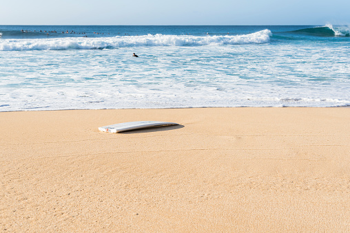A broken surfboard at the beach