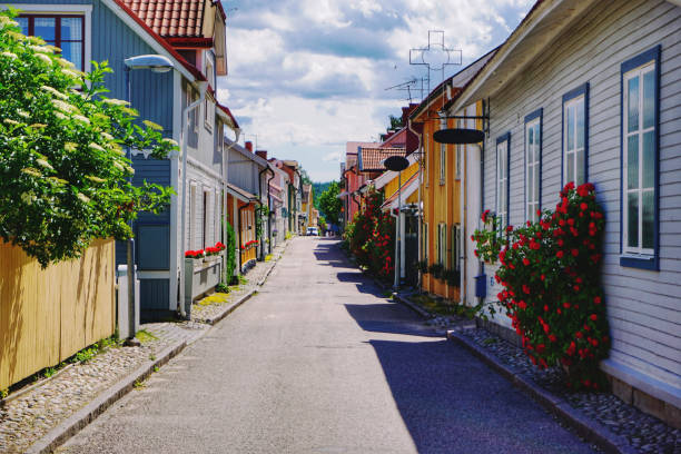 istock empty road amidst buildings against sky 1420024391