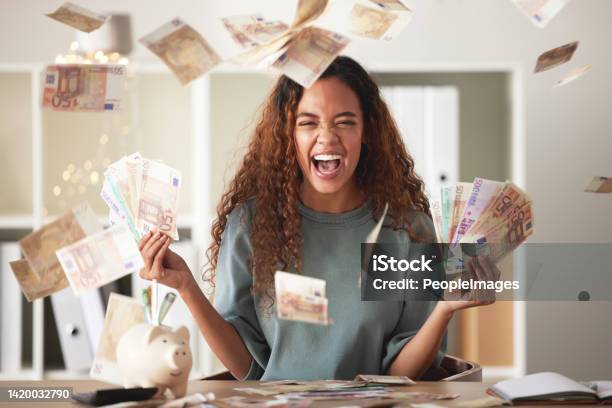 One Happy Young Mixed Race Woman Feeling Rich And Successful While Throwing Money At Home Excited Hispanic Celebrating After Saving And Budgeting Finances Planning For The Future Or Win A Lottery Stock Photo - Download Image Now