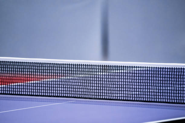 istock Blue and smooth surface table tennis table with tight black net to being prepared for practice and competition. 1420033982