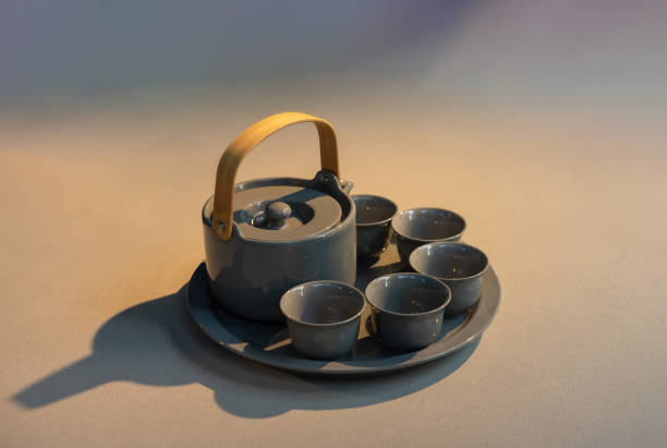 TeaPot ceramic set with New contemporary Modern and Vintage combination style on flat stone kitchen counter with sunlight from window.