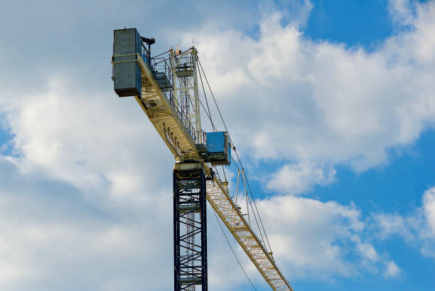 construction crane against cloudy sky - george mason imagens e fotografias de stock