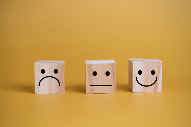 istock Customer service and Satisfaction concept happy Smiley face icon.Business feedback positive rating very impressed wood cube on table. 1420035517