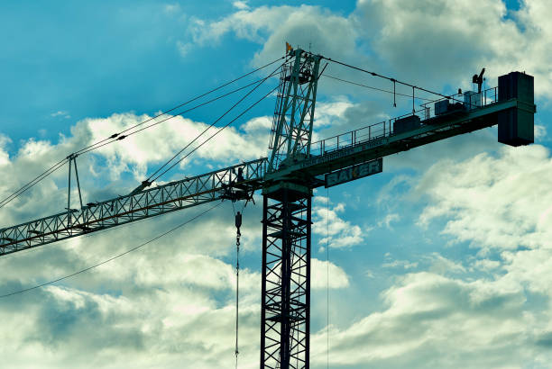 construction crane against cloudy sky - george mason imagens e fotografias de stock