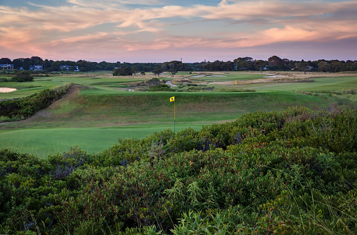 View of Maidstone Club Golf Course in East Hampton, Long Island, New York.  Maidstone Club is a private membership club.  View of 8th hole in the foreground, over sand dunes.