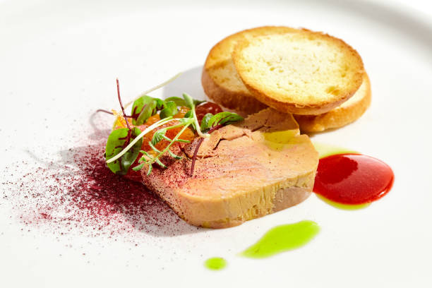 istock Chicken liver pate with toasted bread and jam isolated on white background. Meat terrine with citrus and toast. Restaurant food - duck pate with baguette on white plate. Meat appetizer. 1420037713