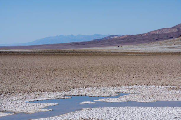 Dry flat salt landscape at the Badwater Basin at Death Valley National Park, California, USA. Seen a hot summer day.