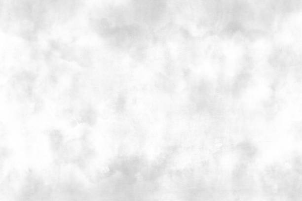 istock Horizontal of monochrome white and light grey coloured wispy cloudy backgrounds with cloudy spots or blotches or smudges all over with copy space 1420046697