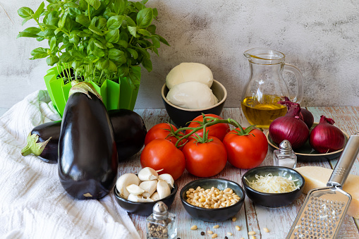 Eggplant and other ingredients for eggplant casserole on a light background, copy space