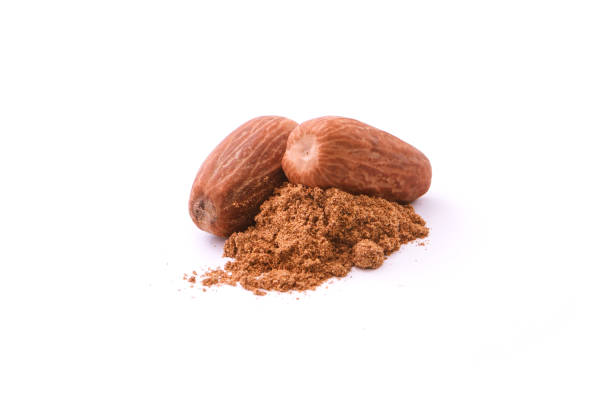 istock Dry nutmeg with powder on white background. 1420047562