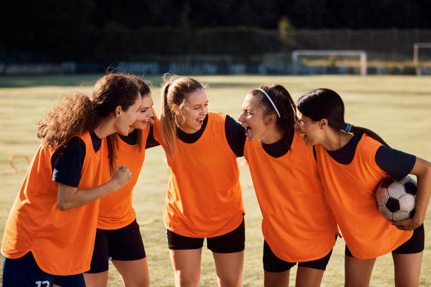 istock Cheerful women's soccer team celebrating victory on a stadium. 1420056768